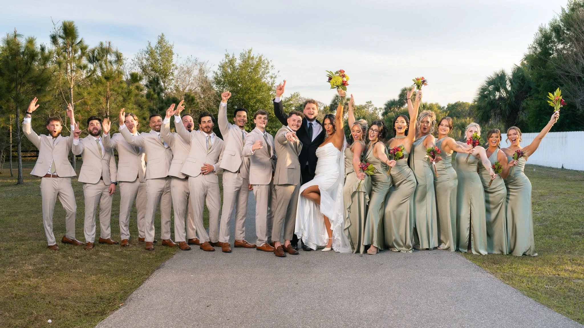 Wedding party cheering outdoors