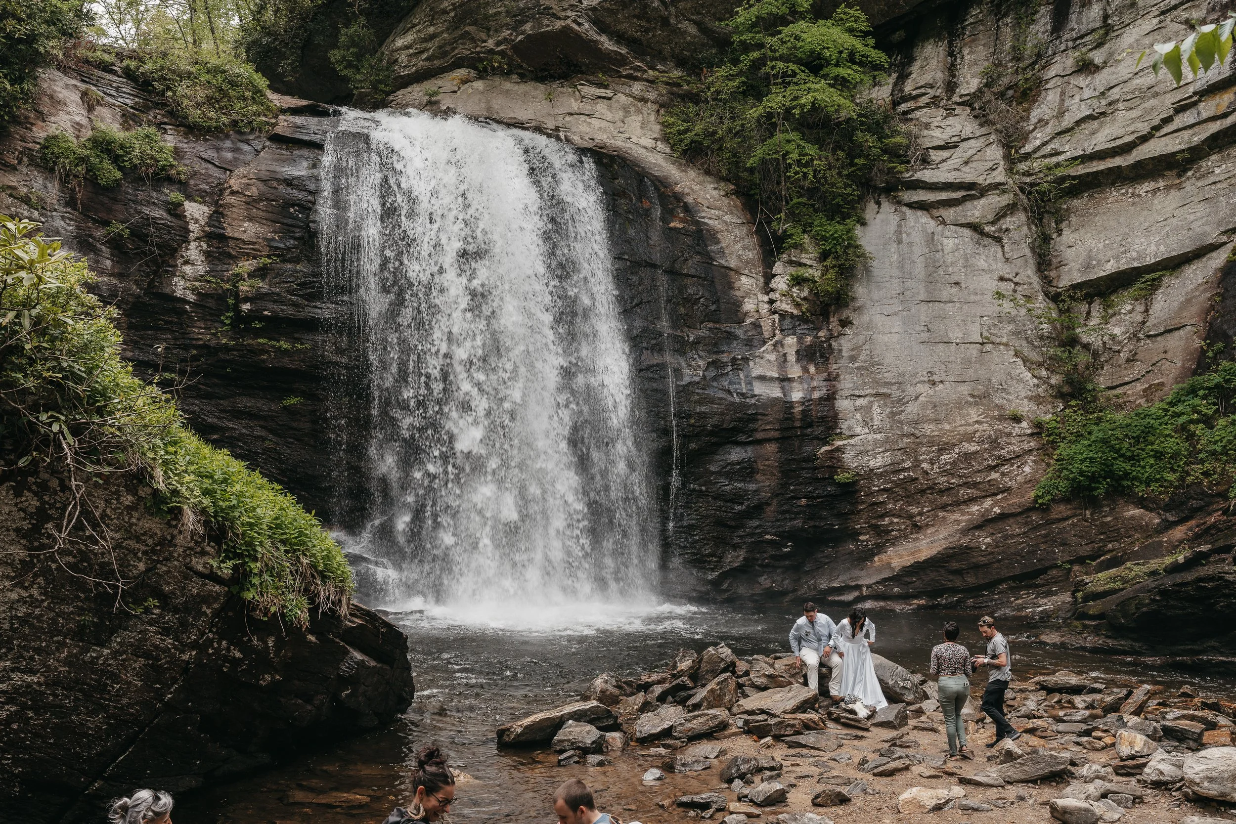 Couple walking past a waterfall